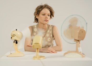 girl sitting with fans